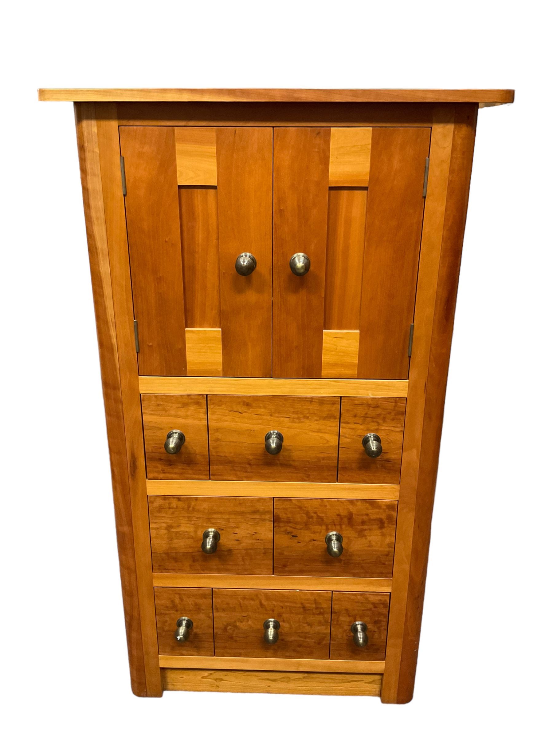 Large contemporary cherry wood break-front wall unit, the banded cornice over double cupboard with bifold doors and two drawers, flanked by four single cupboards, the base fitted with four drawers over four cupboards (W263cm, H216cm, D68cm); and a cherry wood cabinet, fitted with double cupboard over two short and two long drawers, with faux drawer facias (W81cm, H138cm, D66cm)