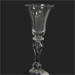 Mid 18th century wine glass, circa 1730-1740, with bell shaped bowl upon an inverted baluster stem with internal tear and basal knop, upon conical folded foot, H15cm