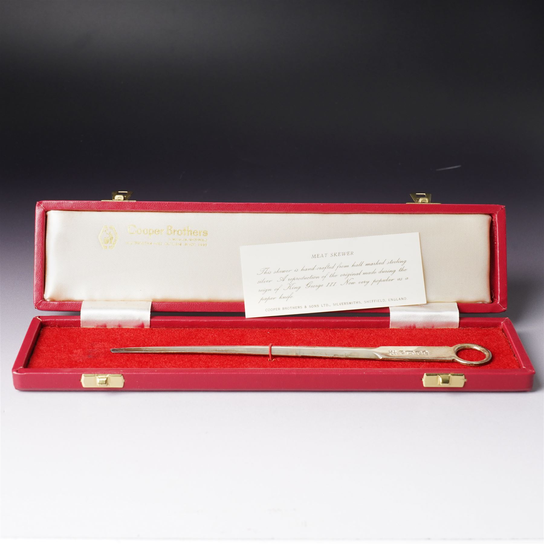 Pair of Edwardian silver candlesticks H16cm Chester 1908 Maker S Blanckensee & Son Ltd and a silver meat skewer/ paper knife, cased Sheffield 1977 Maker Cooper Bros