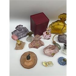 Art Deco style glass perfume bottles and atomisers, to include a large amber example with stopper of fan shape, H18cm, green glass examples with metal stoppers, and a number of other Art Deco style coloured bottles of geometric form with stoppers and mounts