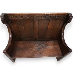 Mouseman - circa. 1920s adzed oak settle or bench, the cresting rail carved with inscription 'Before Honour is Humility', four panel back and plank seat on shaped end supports carved with grotesque masks terminals, carved with mouse signature, by Robert Thompson of Kilburn 
