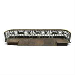Victorian pierced brass fire fender, the pierced scrolling gallery of Aesthetic taste with applied roundels and protruding lobed mounts, raised on bun feet