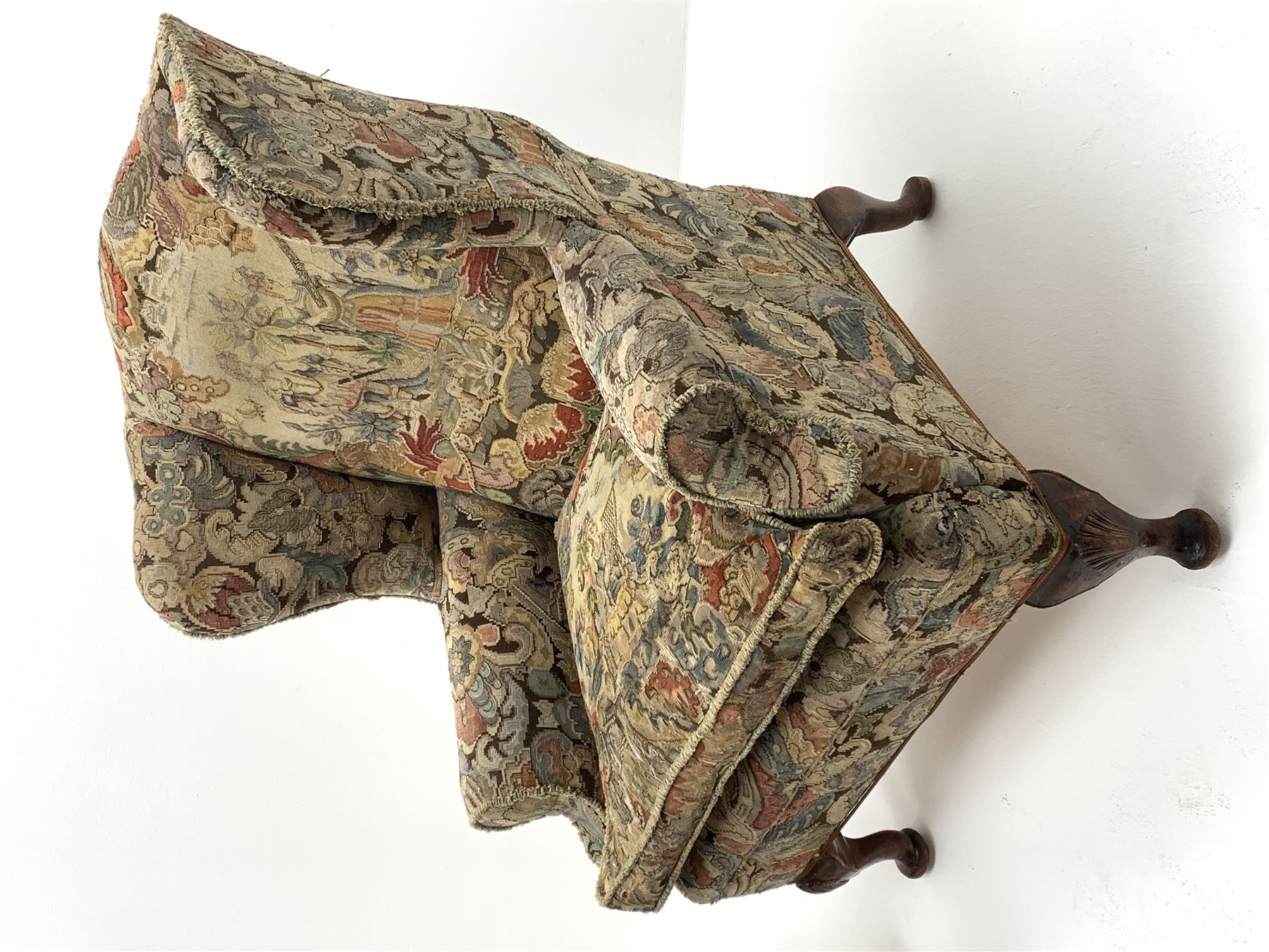 Matched pair early 20th century Queen Anne style wingback armchairs, walnut framed, sprung seats with seat cushions upholstered in needle work cover, shell carved cabriole front feet