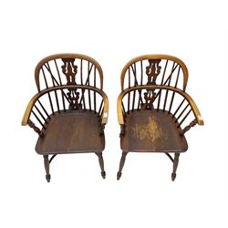 Pair late 20th century oak Windsor elbow chairs, double hoop and stick back with pierced and fretwork work splat, dished seat on turned supports joined by crinoline stretcher