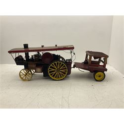Scratch-built red and yellow painted live-steam scale model of a Showman's Traction Engine, 'Supreme' S.A. Oates & Sons, the simulated planked wooden canopy with twisted brass supports and rope light edging, 19cm flywheel, 32cm diameter rear wheels with solid rubber tyres and 21cm diameter front wheels L102cm; together with scratch-built ride-on two-wheel trailer L58cm, Franzus step-down transformer and various brass rally plaques for 1980s/1990s