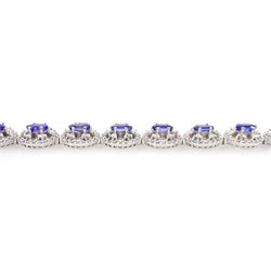 18ct white gold tanzanite and diamond bracelet, twelve oval link clusters set with oval cut tanzanite's and round brilliant cut diamonds, stamped 750, total tanzanite weight approx 7.15 carat, total diamond weight approx 4.00 carat