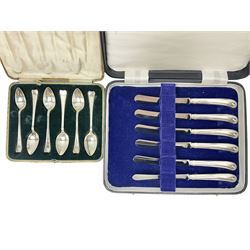  Set of six 1920s silver spoons, hallmarked, together with a set of six silver plated piston grip handled butter knives, both within fitted cases