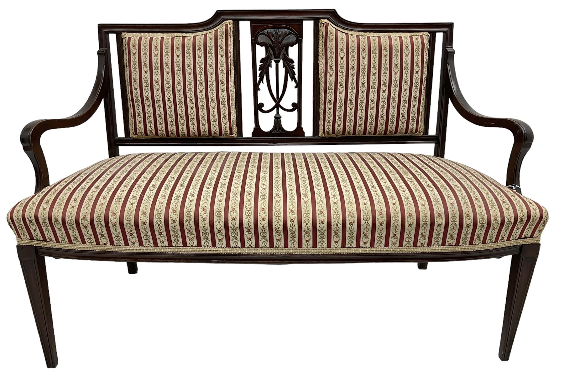 Edwardian mahogany framed three-piece salon suite - two-seat sofa, stepped cresting rail over acanthus and scroll carved pierced splat, upholstered in striped fabric (W124cm, H87cm, D62cm); and a pair of matching armchairs (W60cm) 
