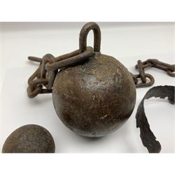 Late 19th/early 20th century prisoners iron ball and chain, with leg manacle; small cannon ball and grape shot