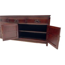 Chinese hardwood sideboard, three drawers above four cupboards, the doors relief carved with flowers and birds 