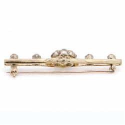 Early 20th century gold and silver diamond brooch, the flower head cluster set with nine old cut diamonds, to split design shoulders, either side set with two further diamonds, total diamond weight approx 1.25 carat