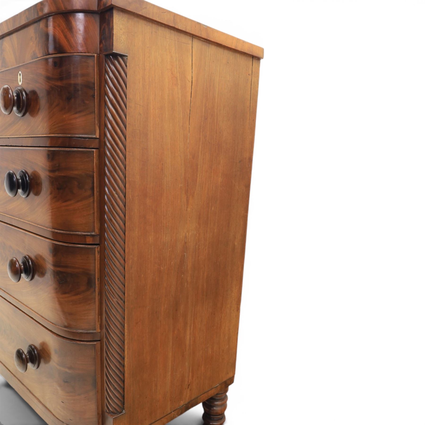 Victorian mahogany bow fronted chest, fitted with two short and three long drawers, flame mahogany front, bone escutcheons and turned wooden handles, quarter barley twist columns, raised on turned supports