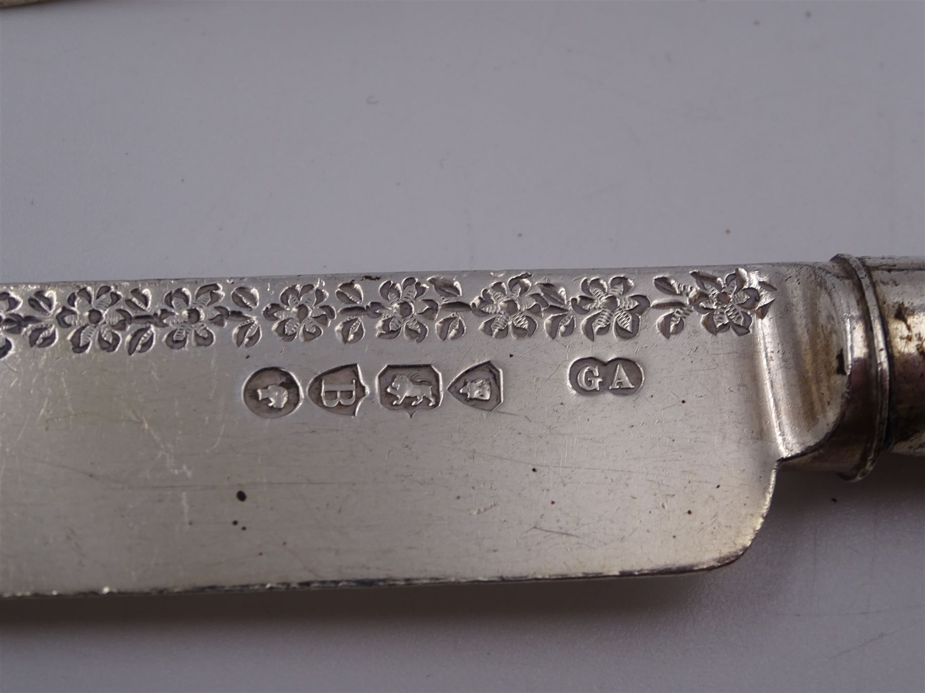 Victorian silver cutlery set, comprising knife, fork and spoon, all profusely engraved with flower heads, each with initials terminals, hallmarked Chawner & Co Birmingham 1877, contained within tooled leather, velvet and silk lined fitted case