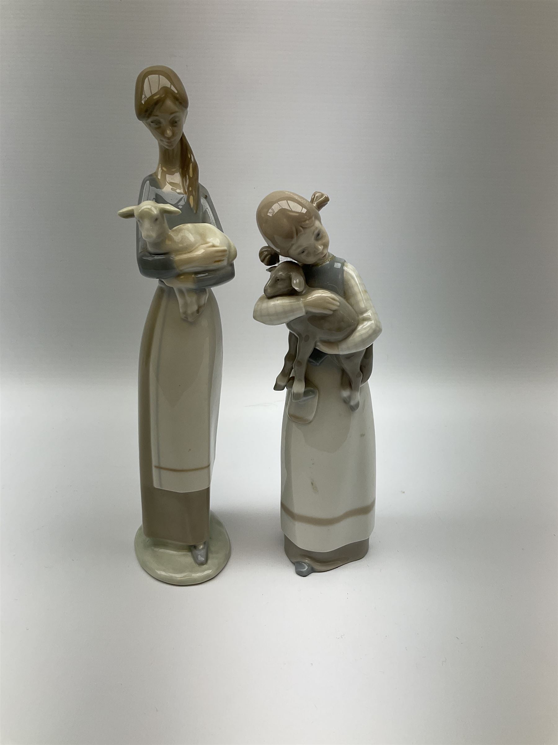 Collection of seven Lladro figures, including Seated ballerina with swan 6204, Childhood Dream 8129, Dancer 5050, reclining clown with ball alongside a selection of other figures. 