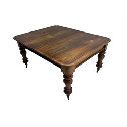 Mid-19th century mahogany dining table, rectangular top with moulded edge over banded frieze, raised on turned and lappet carved supports terminating in brass cups and castors