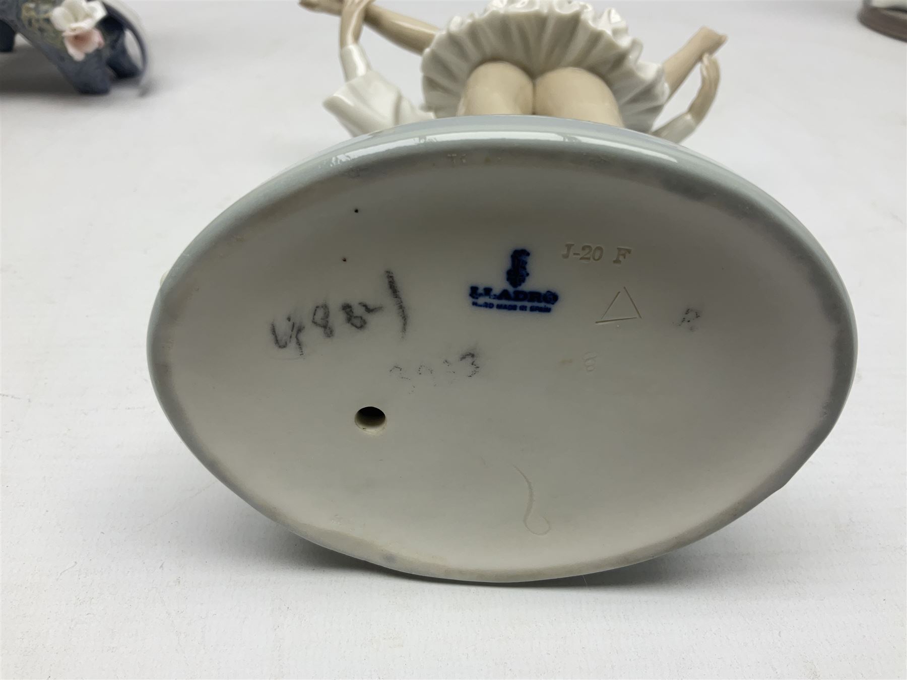 Four Lladro figures, comprising Touch of Class no 5377, Boy Student no 4517, Ocean Beauty no 5785 and Carnival Couple no 4882, largest example H45cm