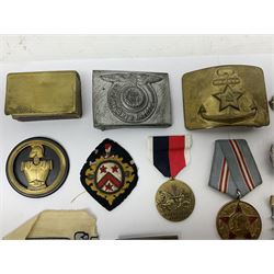 Collection of approximately sixty worldwide medals, metal badges, belt buckles, cloth badges, trench art, brass button stick etc