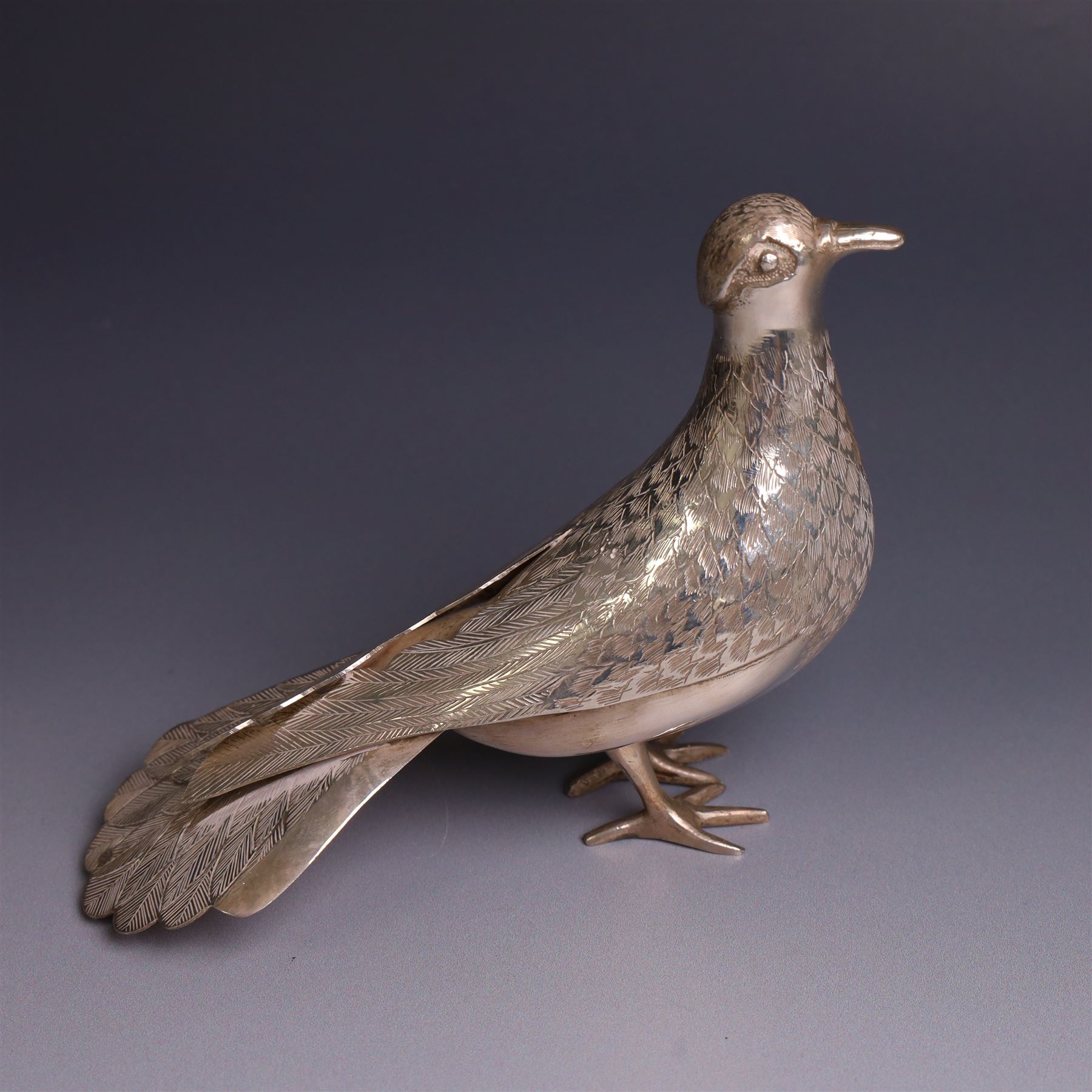 Mid 20th century Iranian silver model of bird, with engraved feathers, stamped with lion with scimitar to underside of tail, H11cm