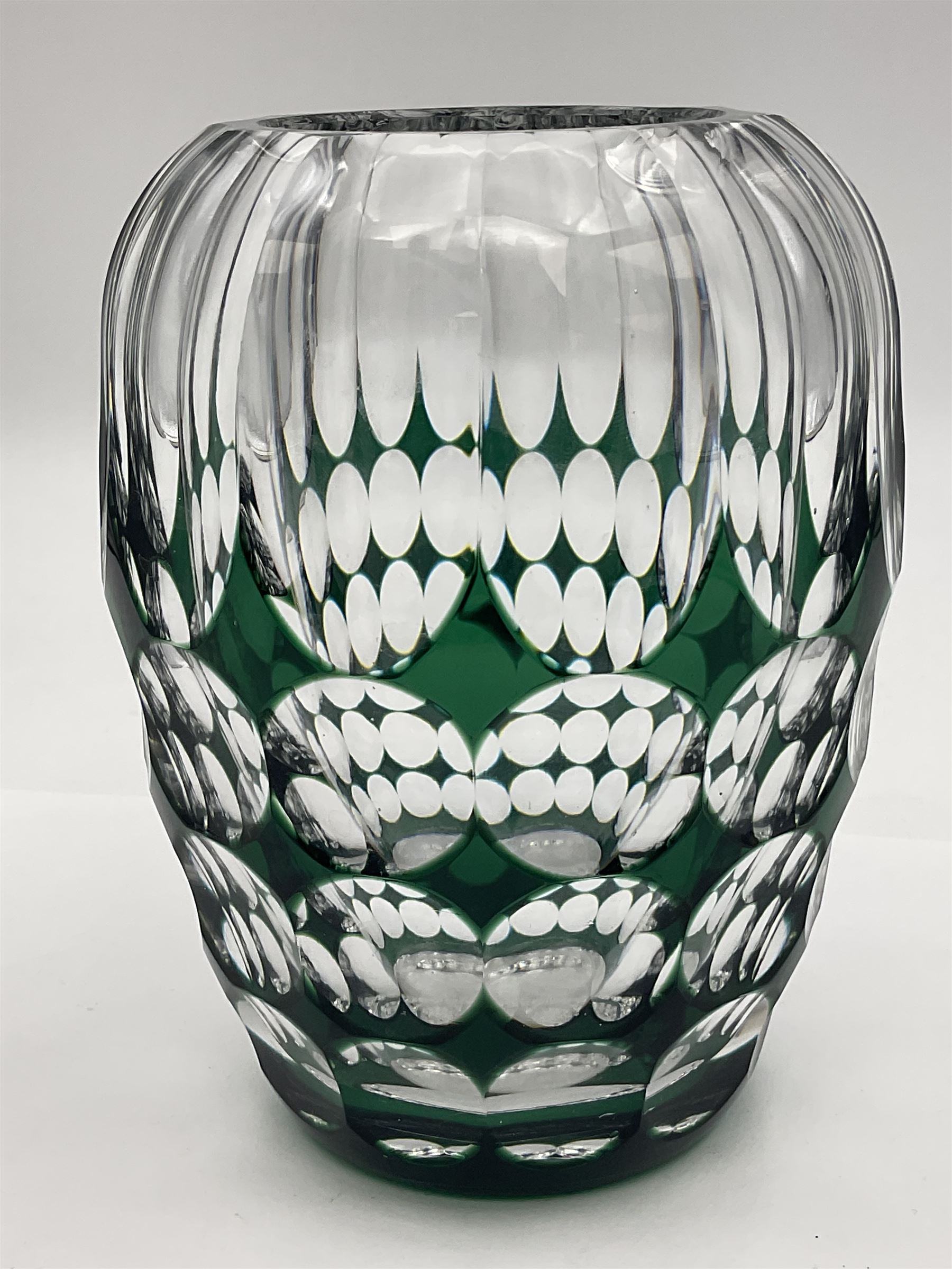 Val St Lambert style glass vase of shouldered ovoid form, cased in deep green over clear and heavily cut with repeat spherical pattern, indistinctly signed beneath ('Jac E. Dalmley'?), H15cm