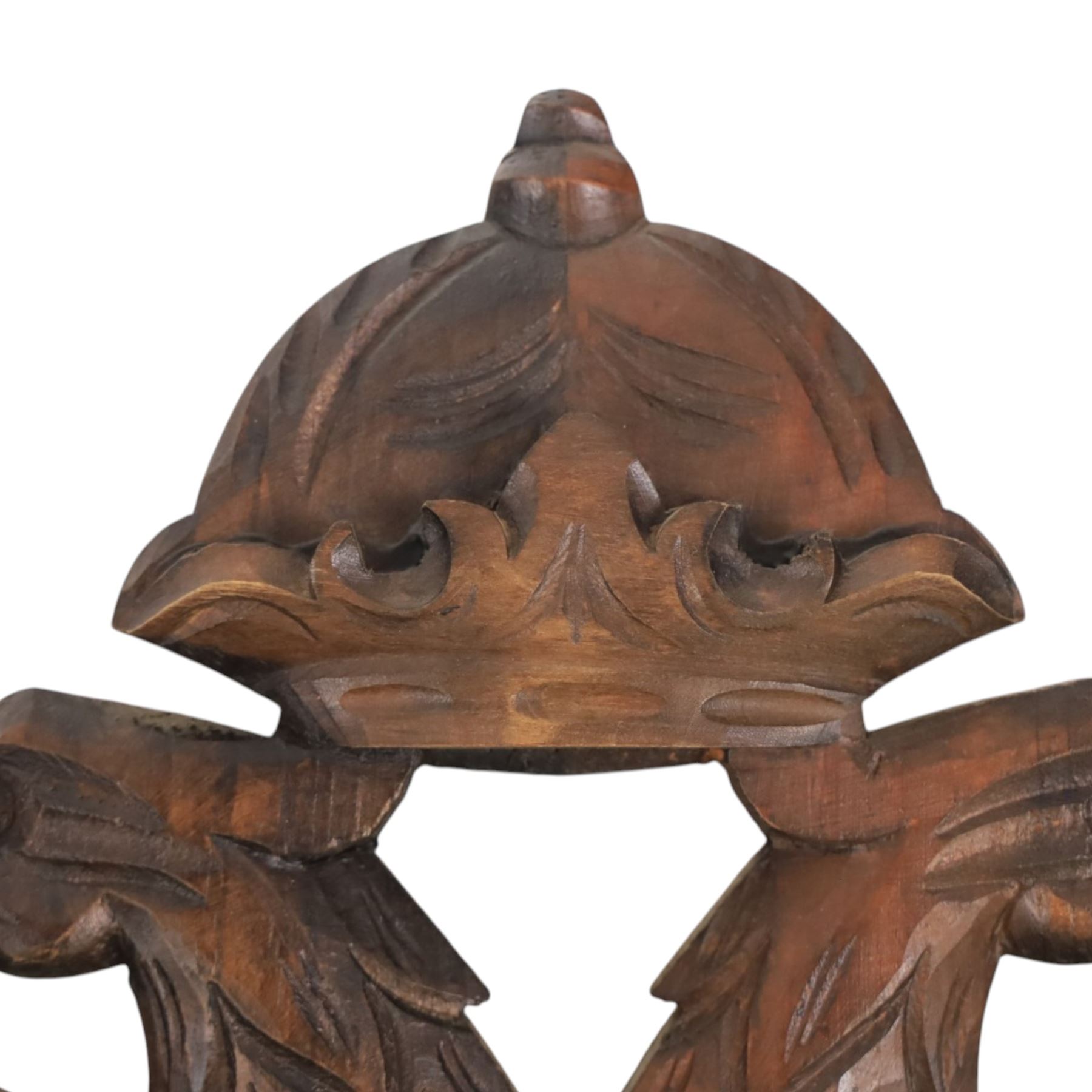 Carved wooden wall plaque, decorated with foliate scrolls, with two reproduction swords attached, together with five other wooden plaques with foliate scrolls and shields