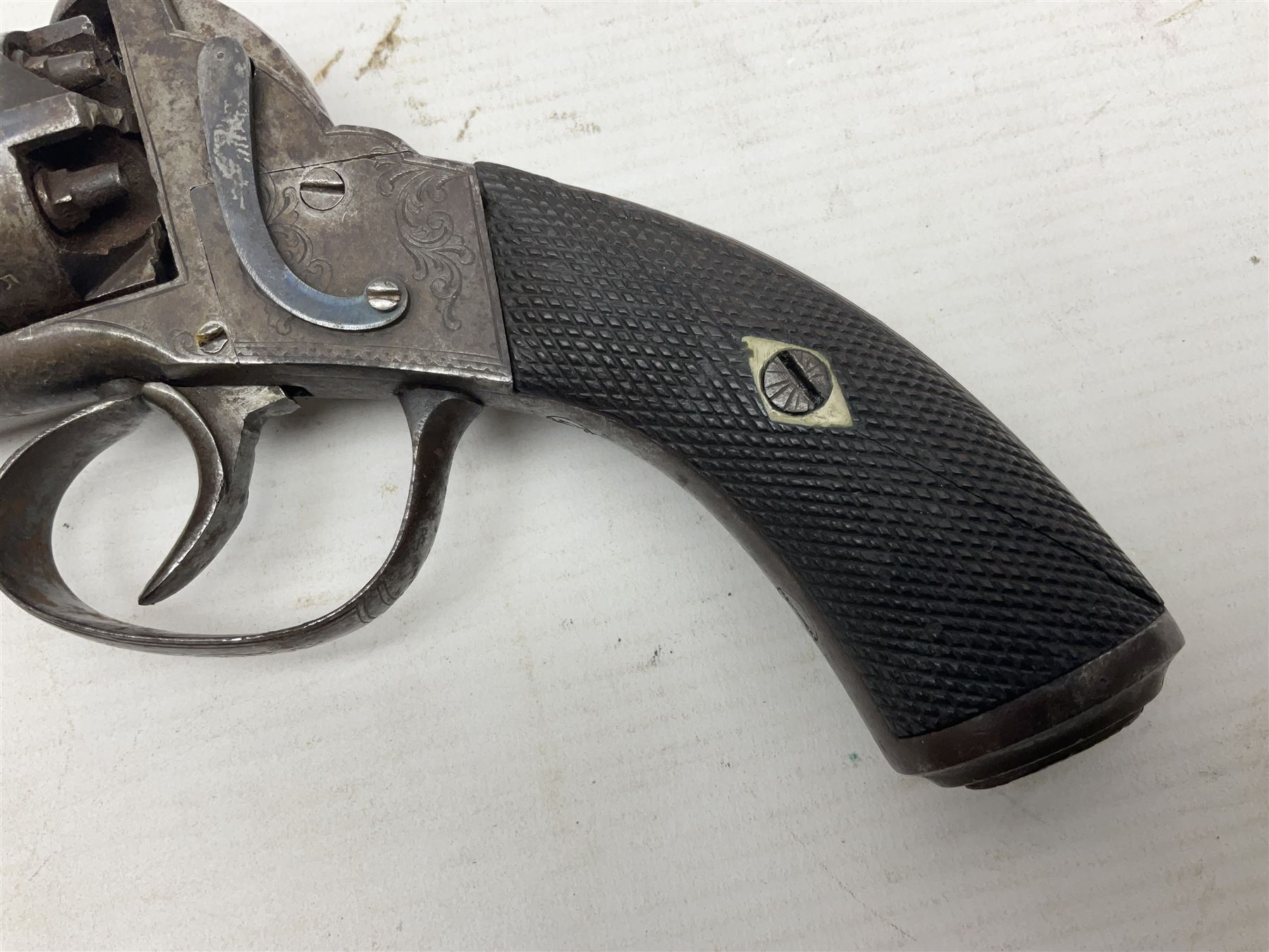 Mid-19th century Smith London .36 cal. transitional five-shot percussion revolver, the 12cm rifled octagonal barrel with side loading lever, side safety, some engraved decoration and chequered two-piece grip L28cm overall