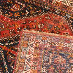 Persian Shiraz crimson ground rug, triple pole medallion surrounded by small stylised motifs depicting birds, animals and plants, within multiple band border each decorated with repeating patterns