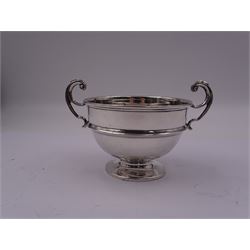 1920's silver twin handled bowl, of circular form with girdle and twin flying scroll handles, upon a spreading circular foot, hallmarked James Woods & Sons, Birmingham 1921, including handles H9cm bowl D10.5cm, approximate weight 4.34 ozt (134.9 grams)