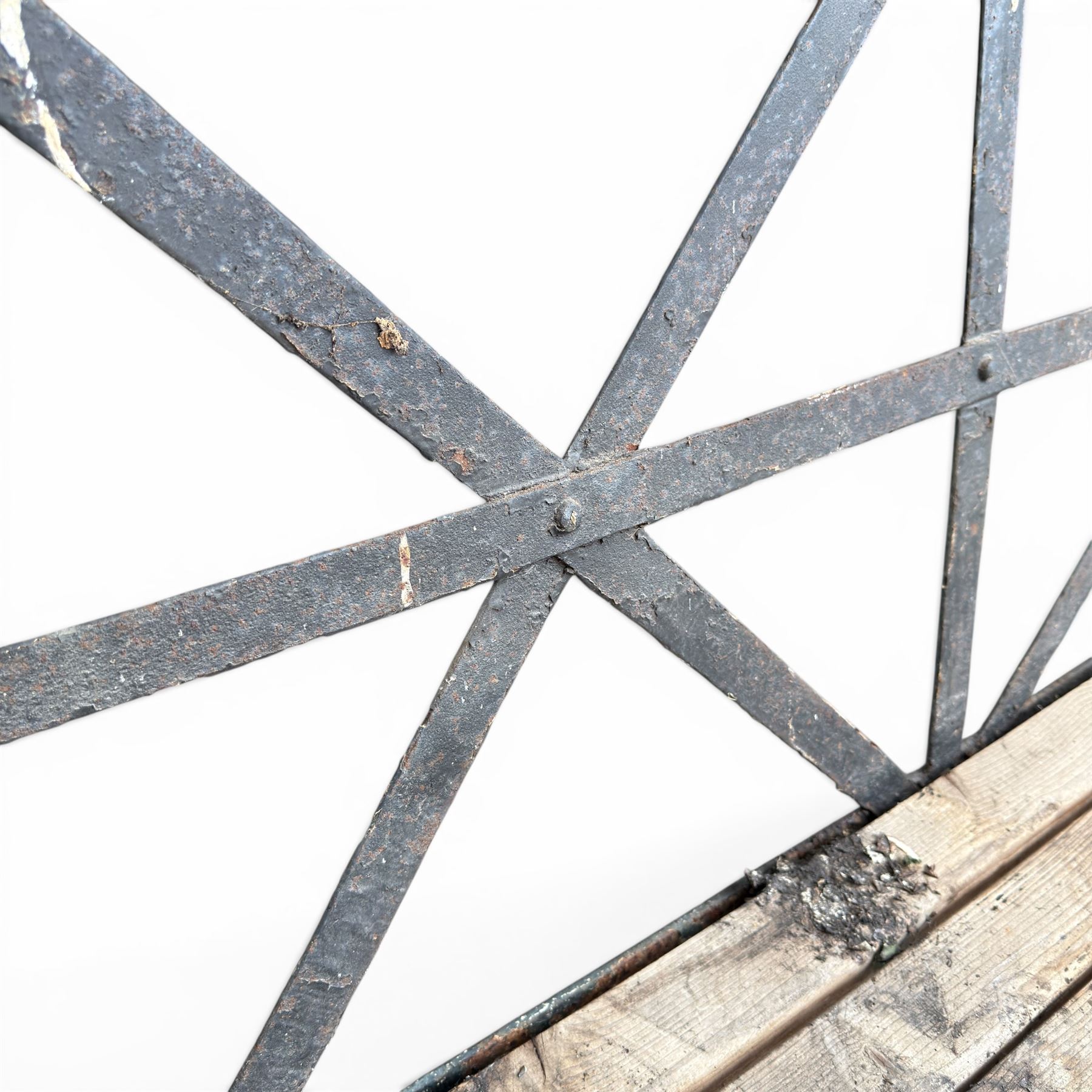 19th century and later Estate made wrought iron strapwork garden bench, the weathered wooden cresting rail over X-form strapwork back and slatted wooden seat