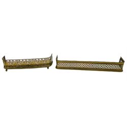Two Victorian brass fire fenders, the larger example with pierced band between rope borders, L119cm, the smaller with foliate pierced bands, upon ball feet, L89cm