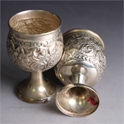 Pair of miniature Indian silver goblets, with embossed floral and foliate decoration, H6.5cm