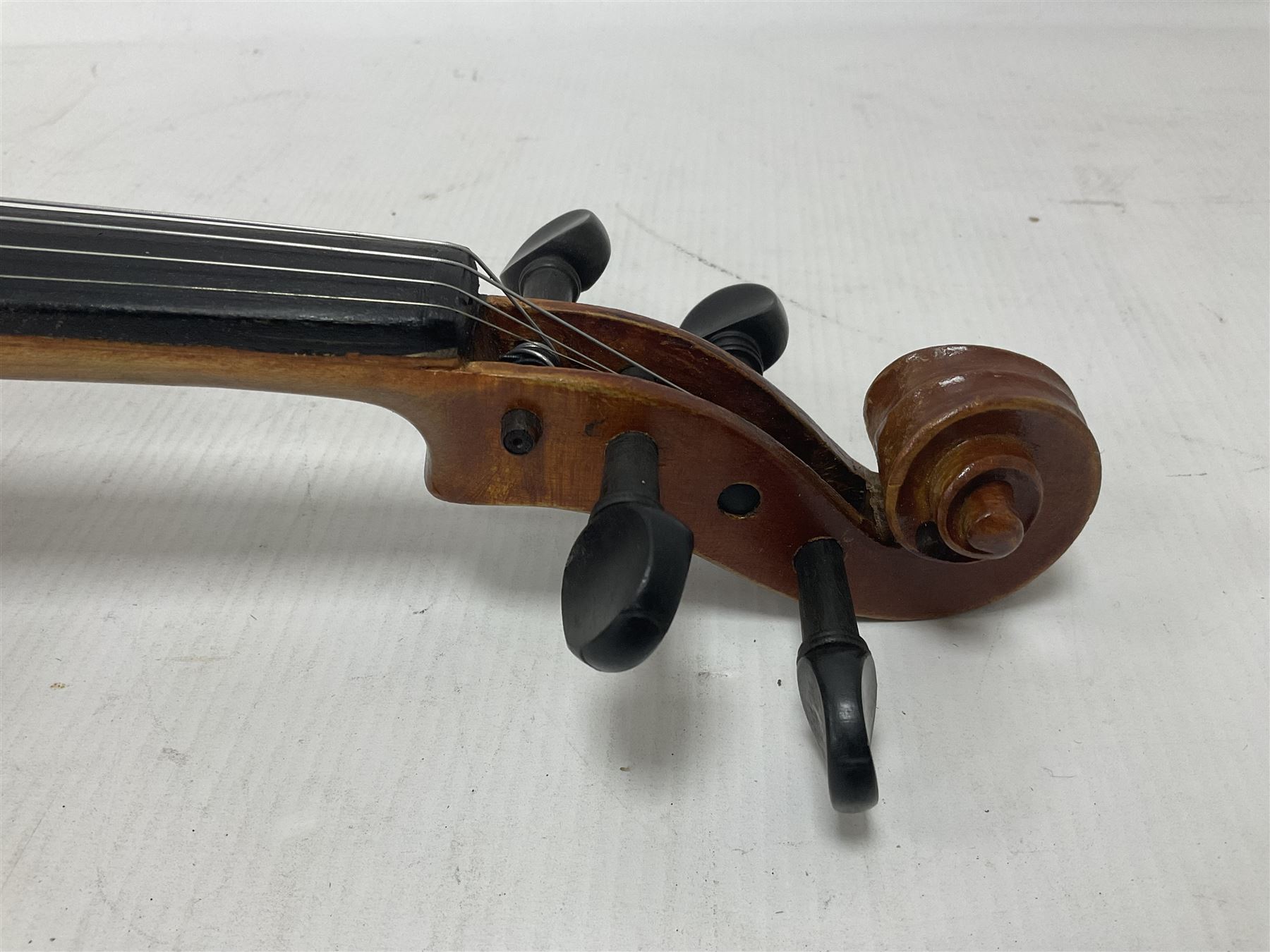 Copy of a full size Stradivarius violin, with an ebonised fingerboard, tailpiece and tuning pegs Length 60cm