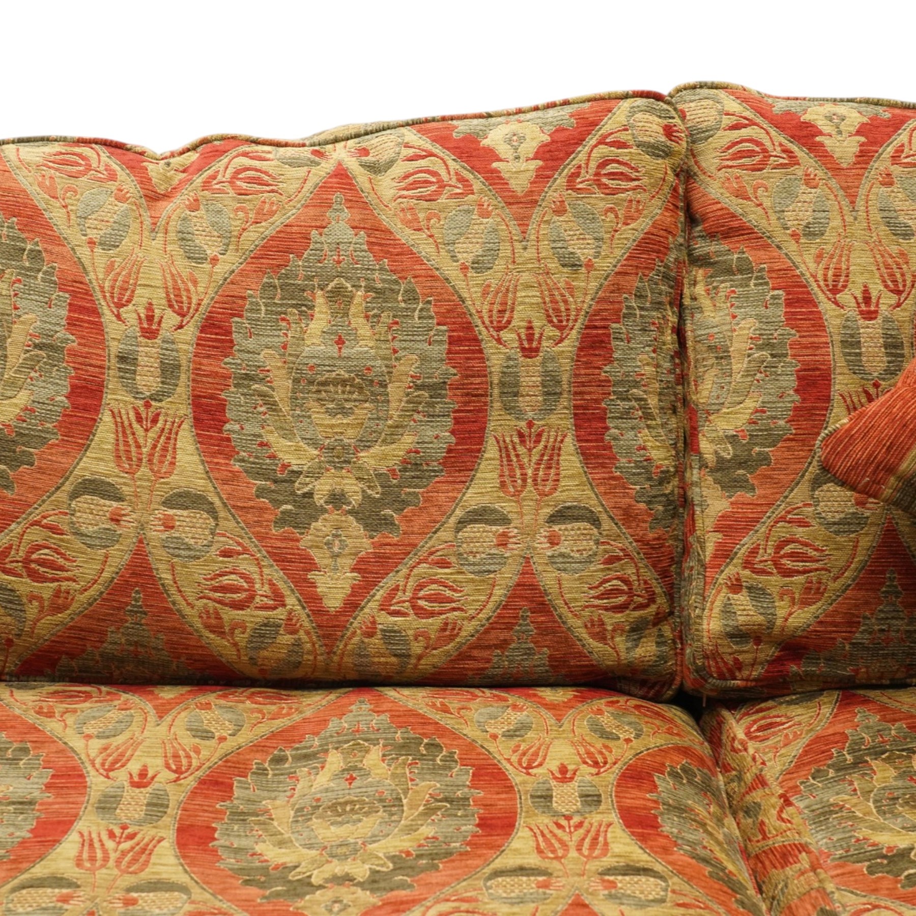 Duresta - traditional shape two-seat sofa with out-swept arms, upholstered in crimson ground fabric decorated with palmettes and foliate motifs with matching loose and scatter cushions, raised on compressed bun feet with brass cups and castors