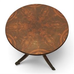 Pair of Georgian design flame mahogany wine tables, circular book-matched veneered tops with moulded edges, on turned pedestals and four reeded downswept supports terminating in brass caps and castors