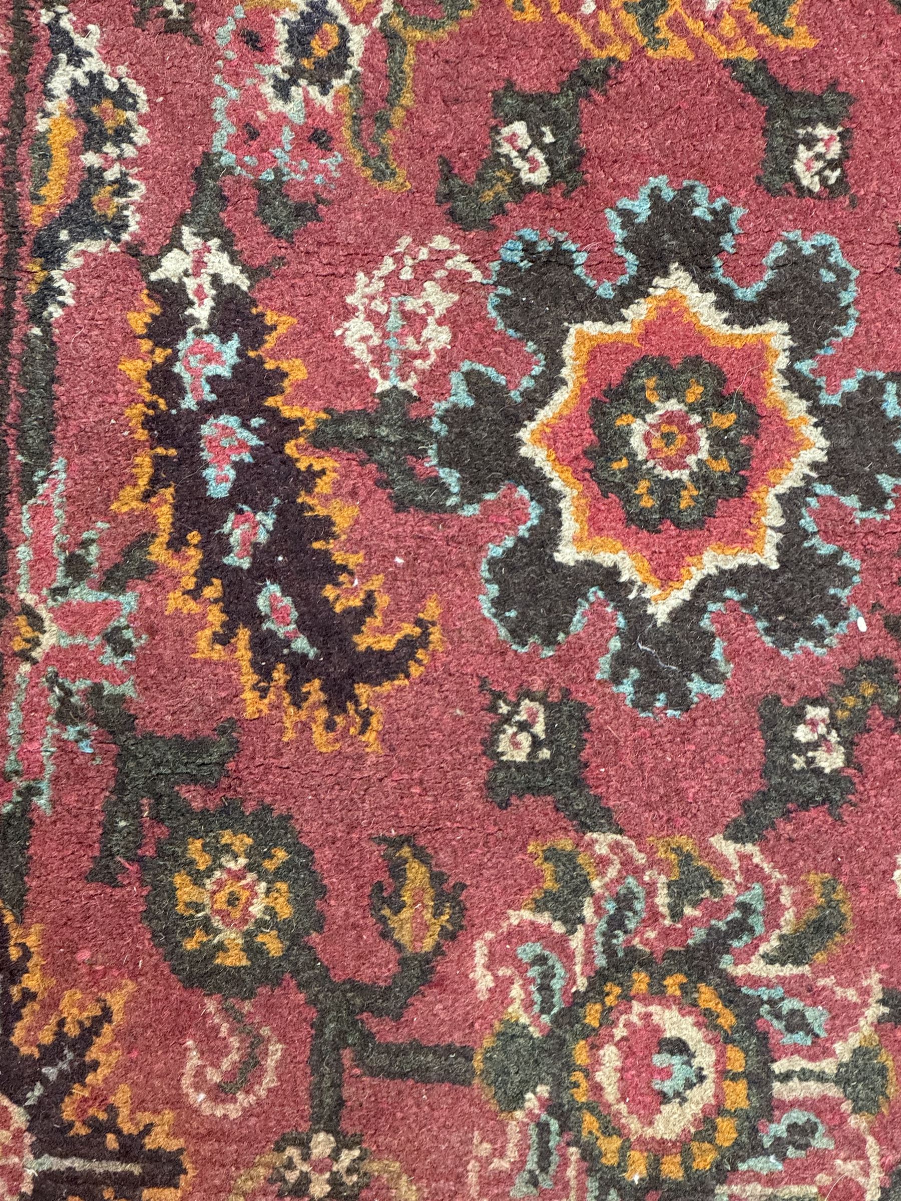 Belgian Sultan woollen ground rug, central navy field densely decorated with floral sprays and geometric patterns (192cm x 135cm); handwoven tribal terracotta ground rug (121cm x 71cm); Persian crimson ground runner, all over stylised floral and foliate motifs (266cm x 94cm)