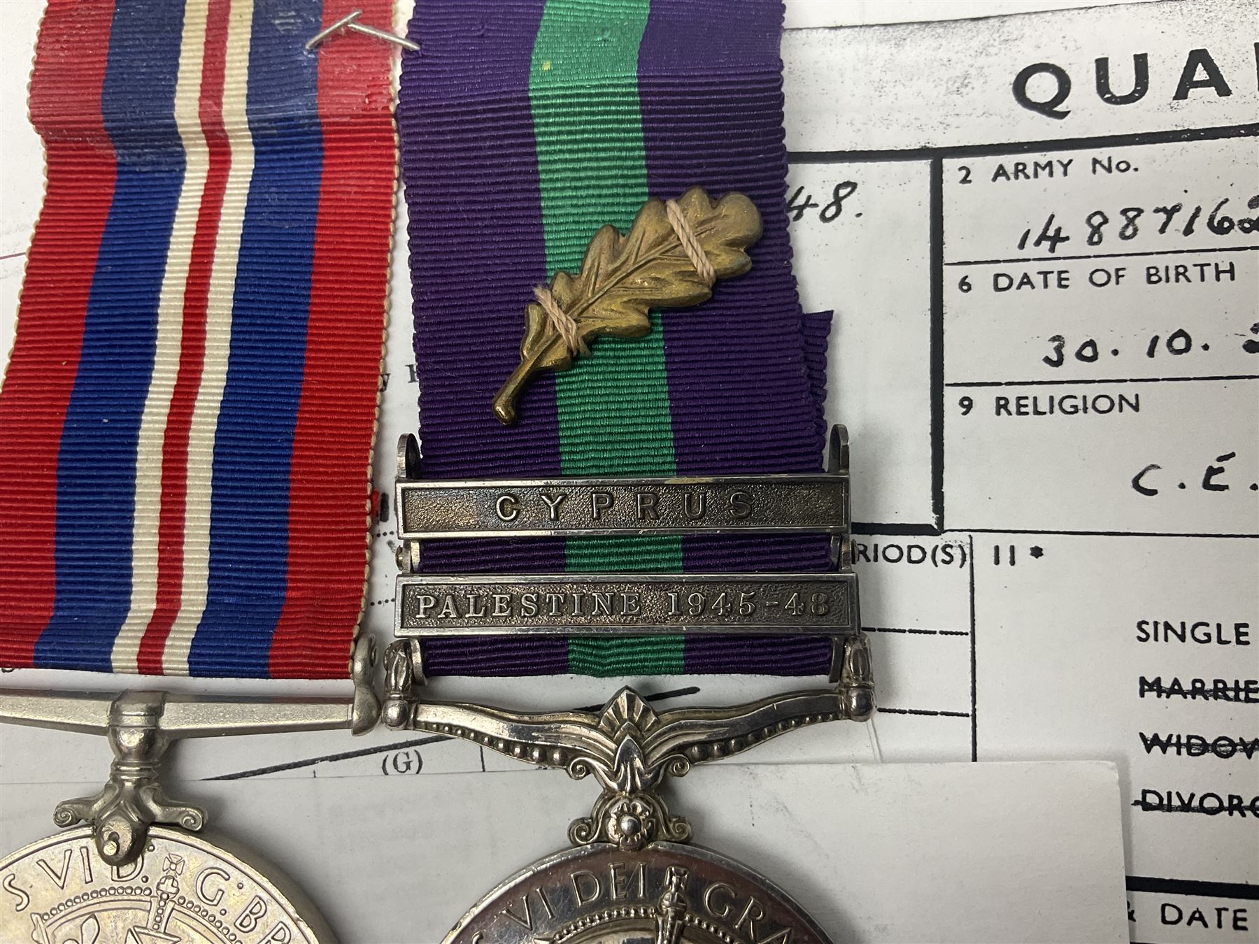 George VI General Service Medal with two clasps for Palestine 1945-48 and Cyprus and MID oak leaf awarded to 14887162 Sjt. C.F.A. Lloyd R.A.M.C. together with WW2 War Medal 1939-1945; both with ribbons; and quantity of photocopied research material including Army Records and London Gazette