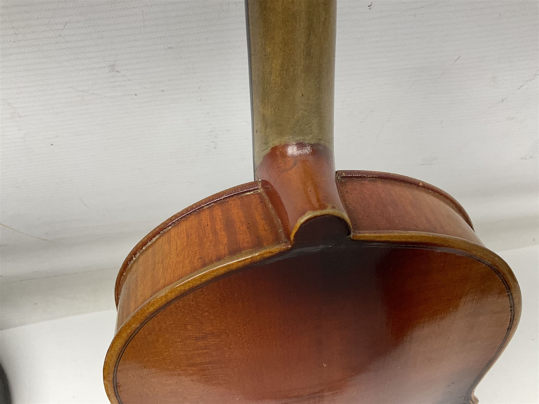 Czechoslovakian violin c1920 with 36cm two-piece maple back and ribs and spruce top, bears label 'Copy of Antonius Stradivarius Made in Czechoslovakia' L59cm; in carrying case; 1950s Czechoslovakian violin; and 195os Czechoslovakian three-quarter size violin; both cased (3)