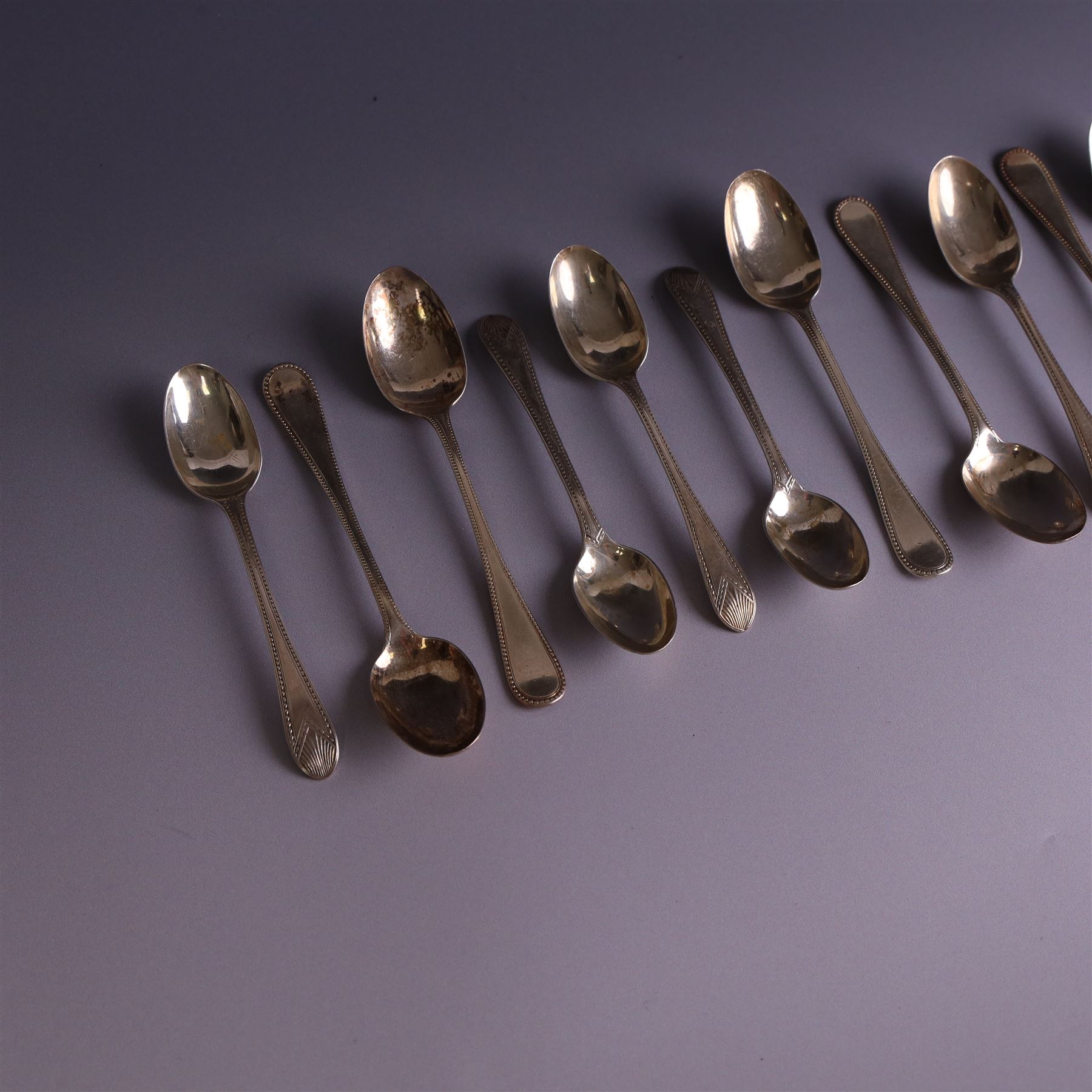 Set of ten silver late Victorian silver teaspoons, with beaded rimg and engraved fan design, hallmarked Thomas Bradbury & Sons, London 1891, and a set of five Victorian silver teaspoons with beaded rim, hallmarked Thomas Prime & Son, Birmingham 1890