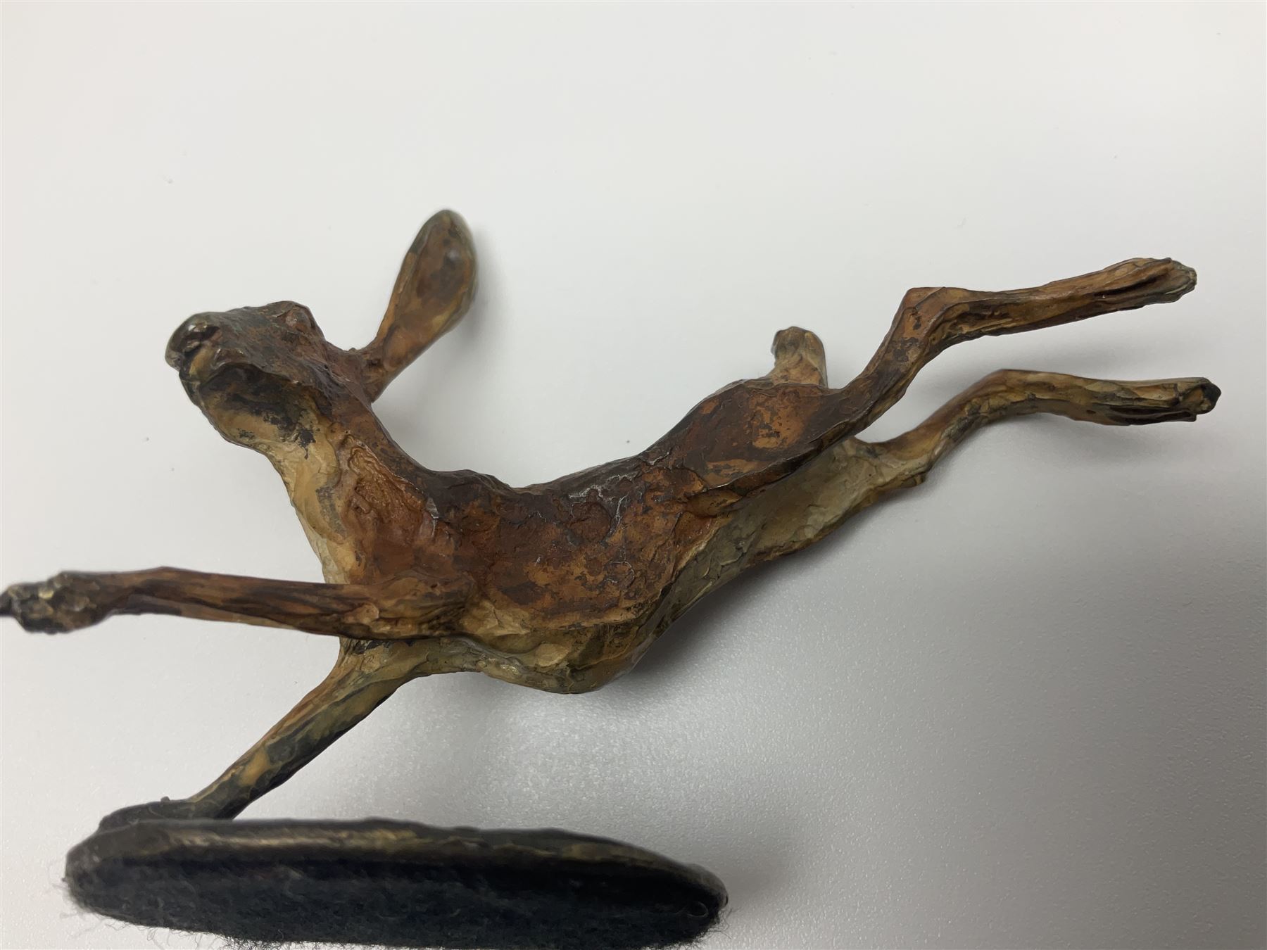 Michael Storey (British 1948-): 'Running Hare', bronze of a hare, H7cm, L10cm 