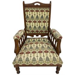 Early 20th century armchair, back and sprung seat upholstered in Art Nouveau patterned fabric, raised on ring turned supports, the frame with all-over reeded decoration