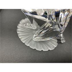 Swarovski Crystal Masquerade trilogy; 1999 Masquerade Pierrot, 2000 Columbine, 2001 Harlequin all with accompanying plaque, stand and original box, together with a glass display case with mirrored back and sides 