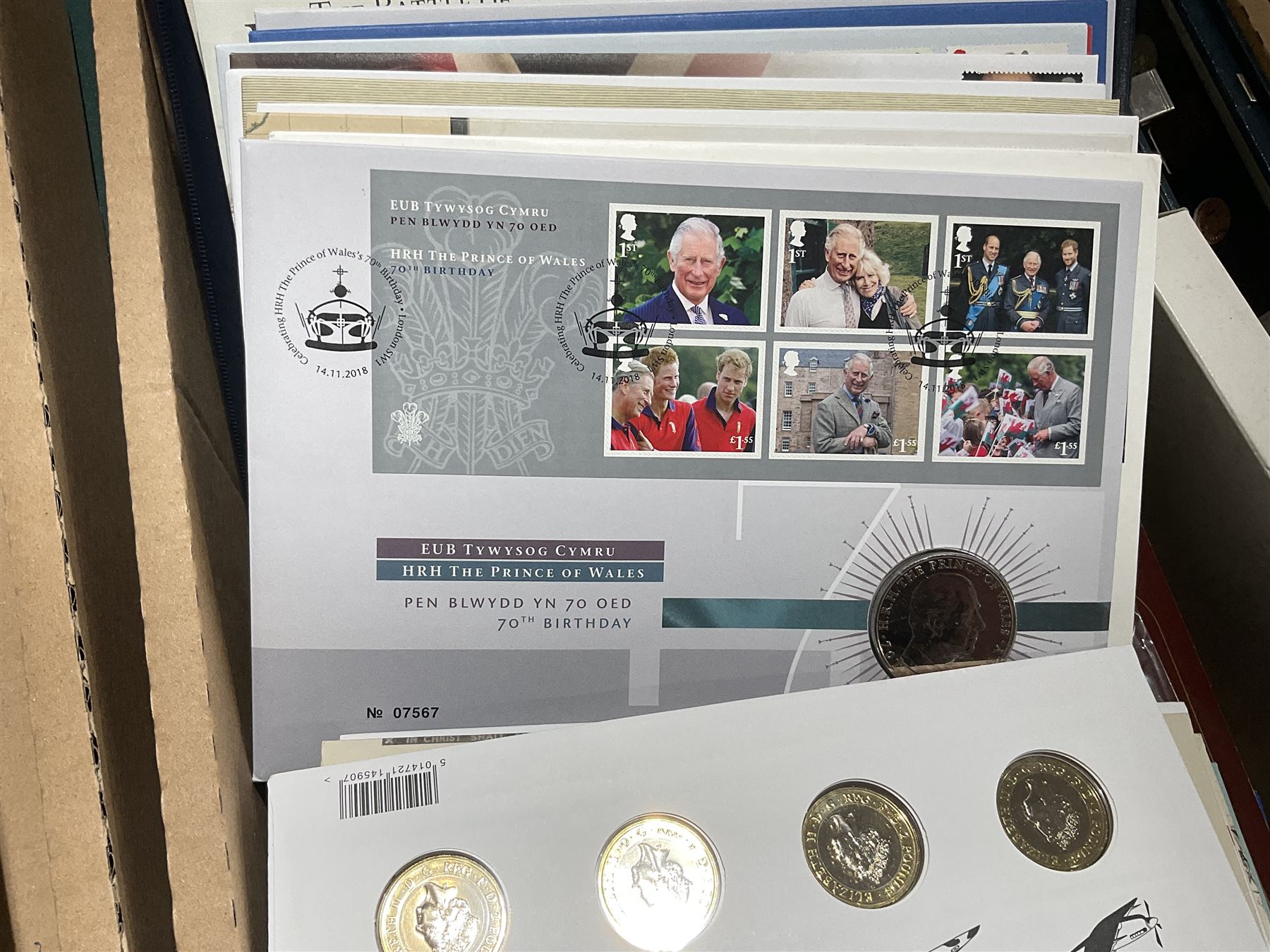 Approximately one hundred and fifteen Royal Mint coin covers, in two ring binder folders and loose, together with approximately 53 grams of Great British pre-1920 and approximately 68 grams of Great British pre-1947 silver threepence coins, and a small quantity of further pre-decimal coins