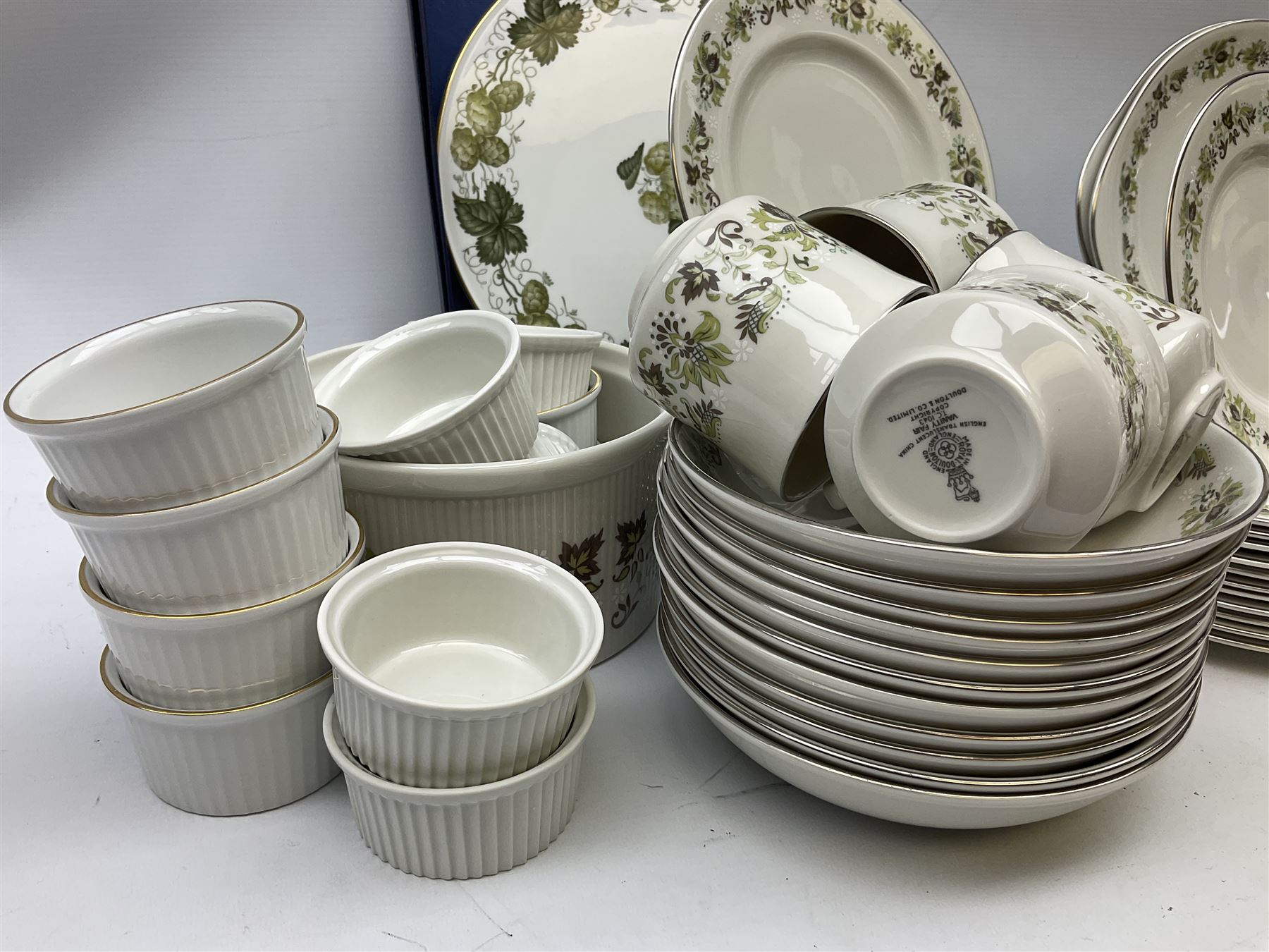 Royal Doulton tea and dinner wares decorated in the Vanity Fair pattern, to include twelve dinner plates, twelve side plates, eleven bowls, three lidded tureens, ten teacups, sauceboat on stand etc, together with boxed Royal Worcester plate, six Royal Worcester ramekins etc
