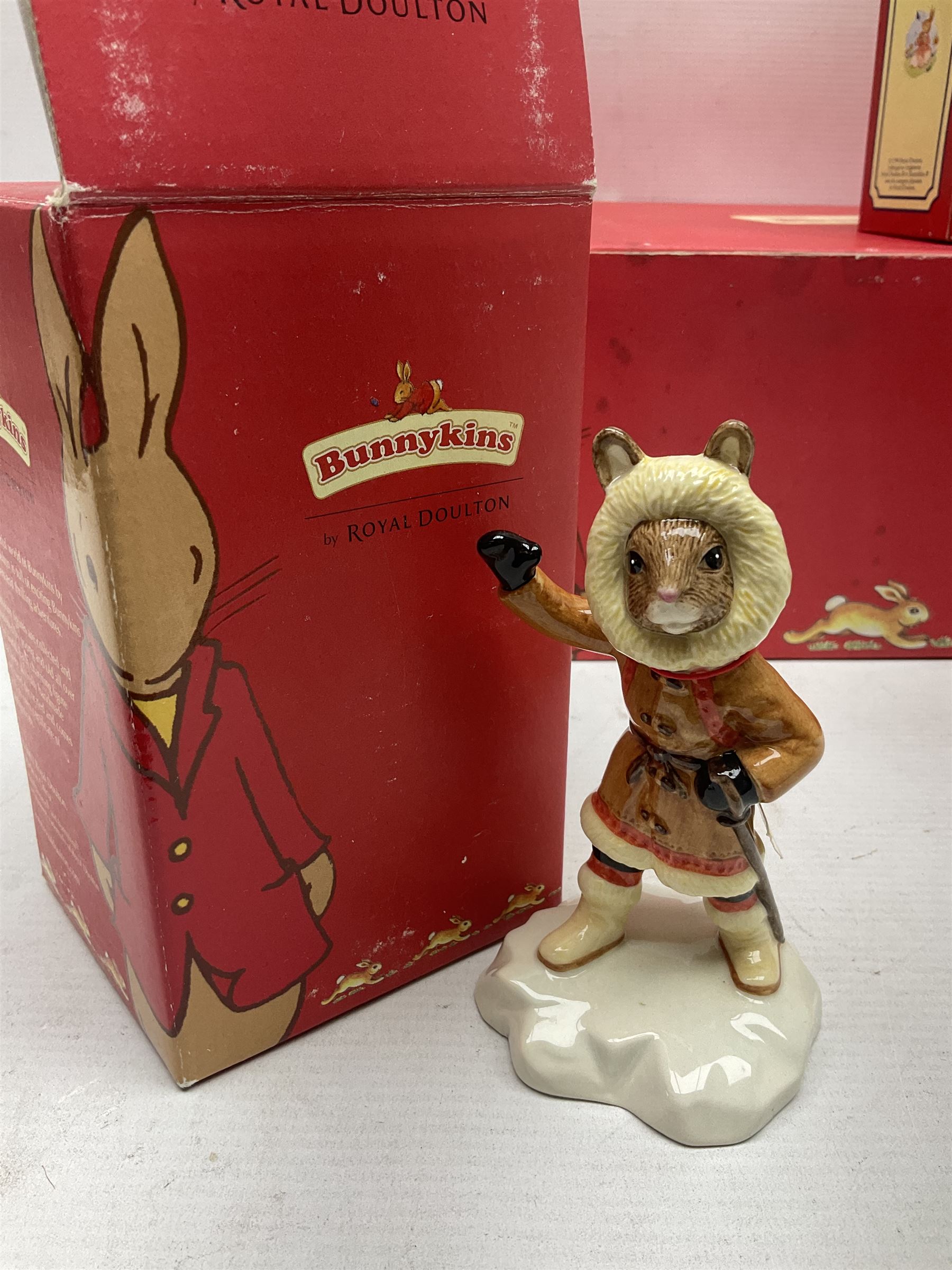 Royal Doulton The Mickey Mouse Collection Pluto figure, Coalport Characters The Snowman Dressing Up figure, three Royal Doulton Bunnykins figures comprising Policeman, Morris Danger and Eskimo, and display stand, Royal Doulton John Beswick Tiggy Winkle, Royal Albert Beatrix Potter Peter Postbag and three Goebel Hummel figures, all boxed