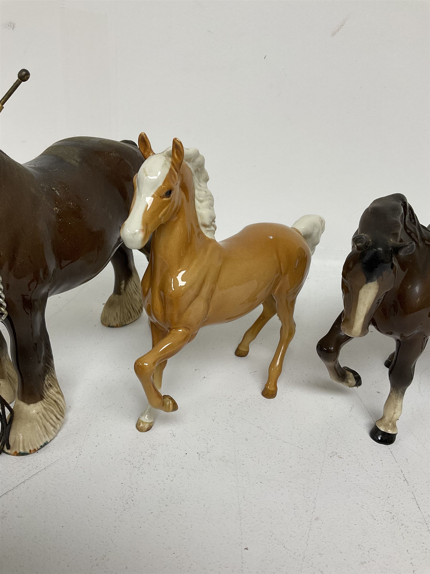 Group of Beswick figures of horses, to include a Palomino horse, Bay Shire horse, recumbent bay foal etc, all with printed marks beneath (5)