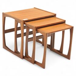 G-Plan - mid 20th century nest of three teak tables, rectangular tops with rounded edges, supported by sculptural open sided frames