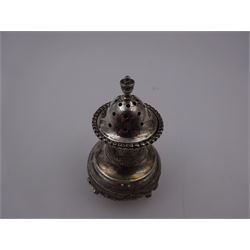 Indian silver pepperette, embossed with agricultural scenes, upon three pad feet, H8cm