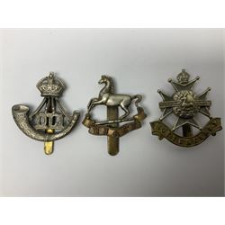 Twenty cap badges including Hertfordshire, Royal Sussex, Cambridgeshire, Hampshire, Notts and Derby, East Surrey, Herefordshire, South Lancashire, Devonshire, Bedfordshire, Durham Light Infantry etc (20)