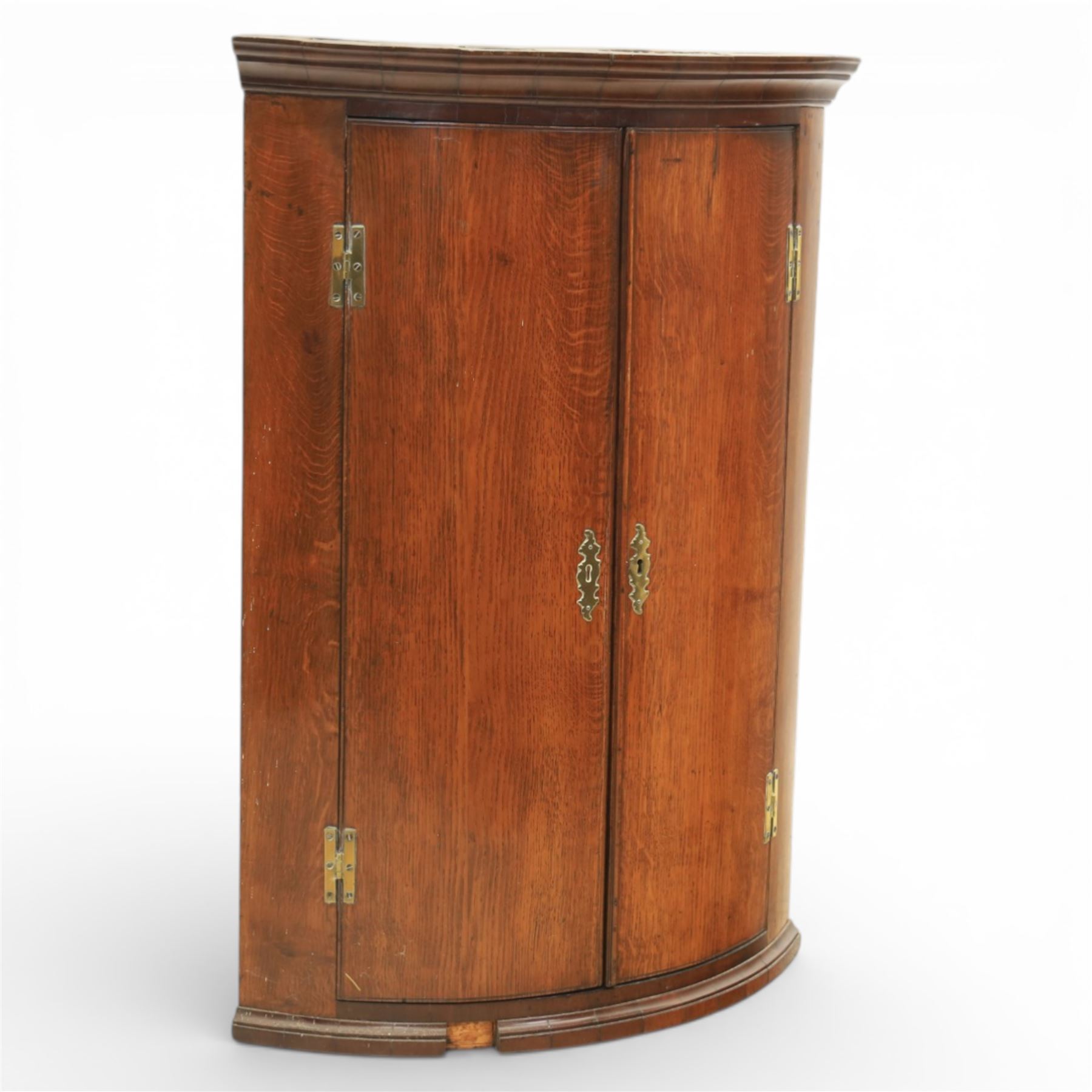 George III oak and mahogany wall hanging cylinder corner cupboard, moulded cavetto cornice over double cupboard enclosing three shelves