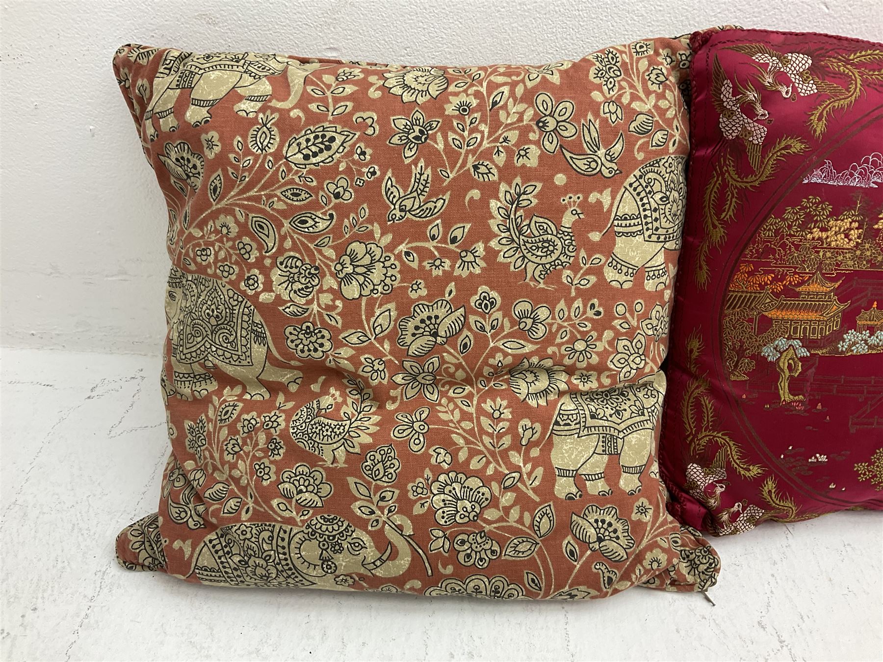 Collection of predominantly Chinese style cushions, to include feather down examples