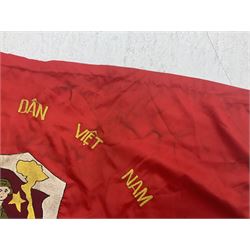 1960s North Vietnam banner embroidered in yellow thread on a red ground, roughly translates as 'Peoples Army of Viet Nam. Warriors of Viet Nam Determined To Keep The Country 1964' around a central military crest with the motto 'Warriors Keep The Country'; tassels to three sides 70 x 100cm